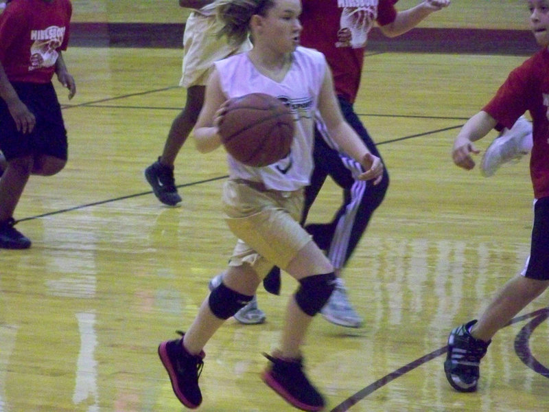 Image: Tara sprints — Hillsboro Red tries to slow down Tara Wallis but to no avail. Apparently, when Tara sees red she becomes a rampaging bull.