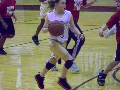 Image: Tara sprints — Hillsboro Red tries to slow down Tara Wallis but to no avail. Apparently, when Tara sees red she becomes a rampaging bull.