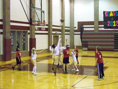 Image: Defense! — Jennifer McDaniel #5, Tylar Wilson #13 and Jaclynn Lewis #22 challenge a Hillsboro Red shooter while sisters Hannah Washington #2 and Madison Washinton #11 and get in rebounding position.