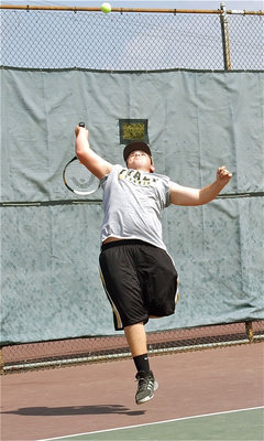 Image: I got it! — Kevin Roldan reaches back for the lob.