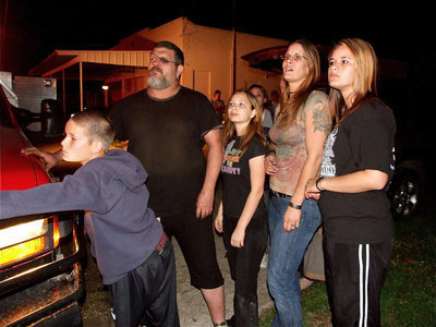 Image: Stunned residents — Along with friends and neighbors, Isaac Salcido, Paige Kelley, Candi Gray-Salcido and Jasmine Salcido witness Milford Cash Grocery being lost to a relentless fire.