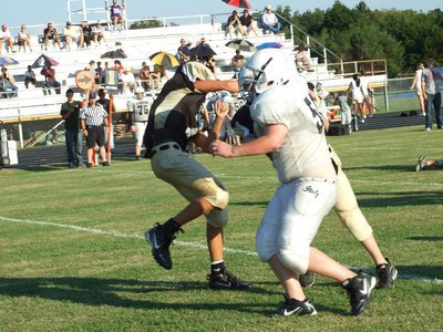 Image: Pocket breaks down — John Byers pressures the Hubbard quarterback resulting in an incomplete pass.