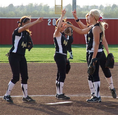 Image: All in — Anna Viers, Morgan Cockerham, Bailey Bumpus and Megan Richards try to inspire a rally.