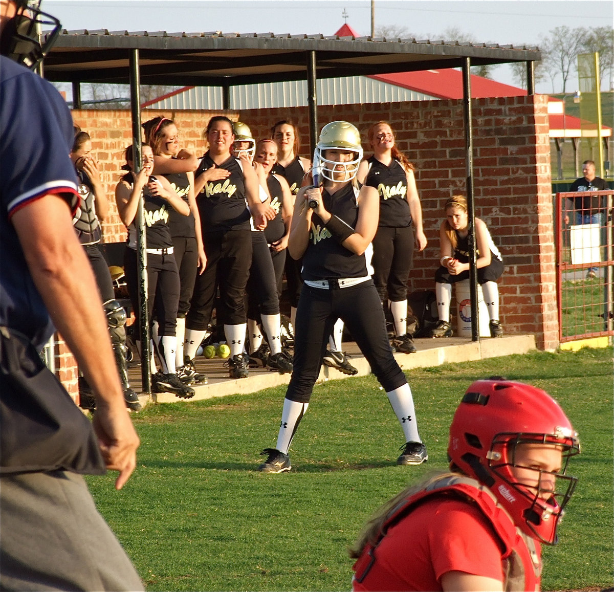 Image: We got your back — The dugout makes some noise as Megan Richards prepares to step up to the plate.