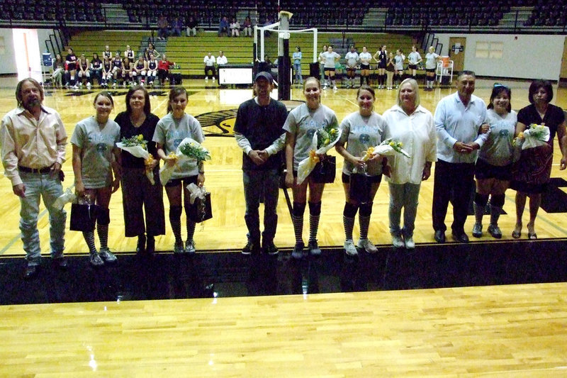Image: Senior and parents — Lindsey Brogden and parents, Randy and Laura; Annalee Lyons (mom, Meg, was announcing); Becca DeMoss and stepdad, Tommy Sutherland; Angelica “Jelly” Garza and mom, Cherilyn Davis; Blanca Figueroa with parents, Javier and Blanca. Everyone received yellow roses draped with their name and number and a picture of the team.