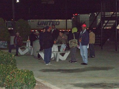 Image: Stranded passengers — Passengers patiently wait while the bus is searched for marijuana.