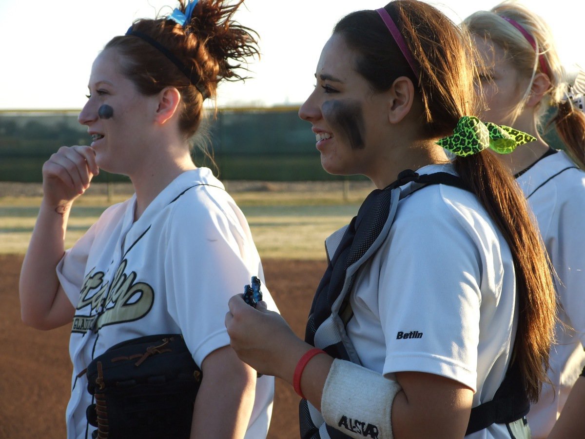 Image: Pre-game cheers — Bailey Bumpus and Alyssa Richards look on during team introductions before the game.