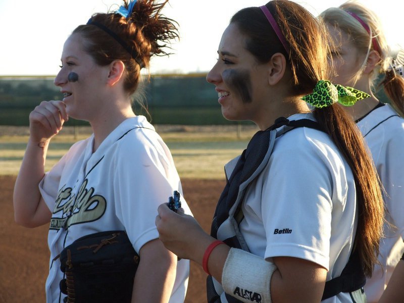 Image: Pre-game cheers — Bailey Bumpus and Alyssa Richards look on during team introductions before the game.