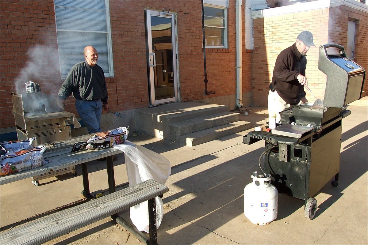 Image: We’re cooking now! — James Viers and Erick Thompson help get Lady Gladiator fans fired-up for the upcoming season during the teams burger fundraiser at the Italy High School Cafeteria.