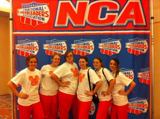 Image: Coronada Springs Resort — The girls took the opportunity to get their picture taken in front of the  big sign, National Cheerleaders Association in the resort they were staying at.