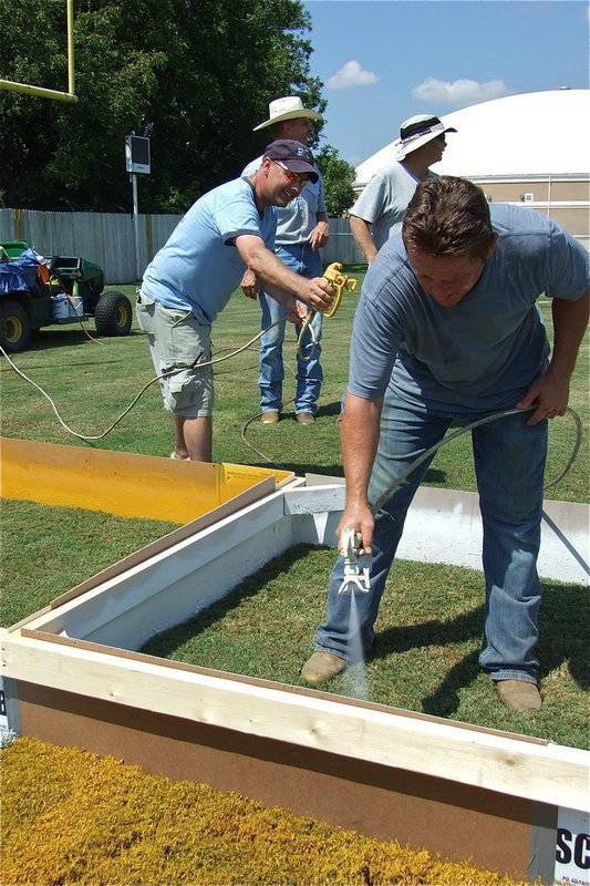 Image: Outside the box — Paul Cockerham takes advantage when no one is looking to tease Jon Mathers.
