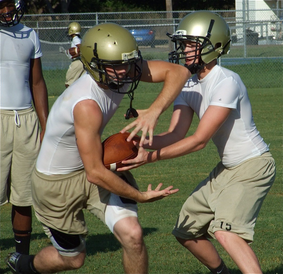 Image: Justin to Kyle — Justin Buchanan hands off to Kyle Wilkins.