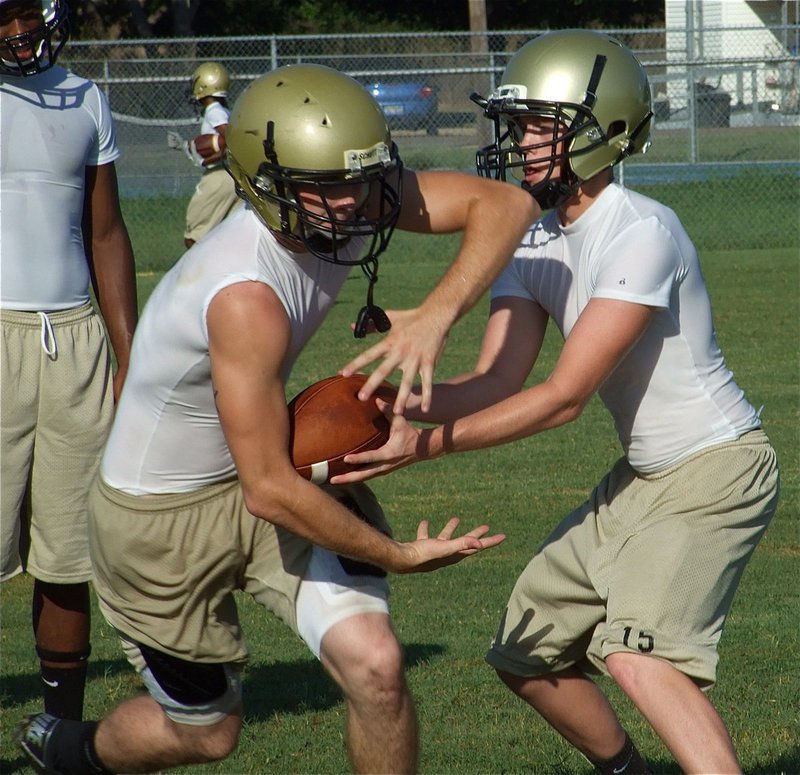 Image: Justin to Kyle — Justin Buchanan hands off to Kyle Wilkins.