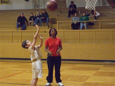 Image: Xander practices — Italy 9’s Xander Galvan(10) practices his shooting form before the game as head coach Deloris Harris observes.
