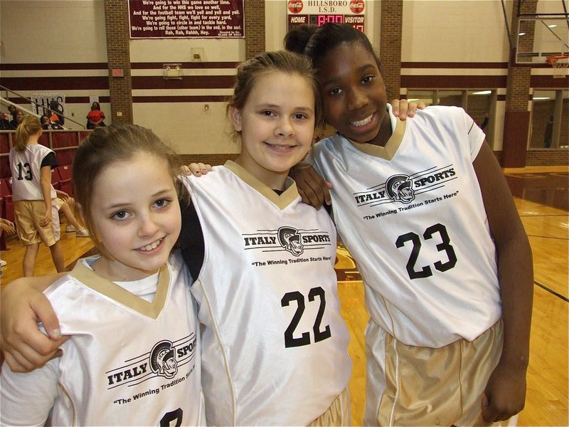 Image: Lean on me — Peyton Henderson(2), Lillie Perry(22) and Janae Robertson(23) lean on one another for support before the game against Hillsboro Black.