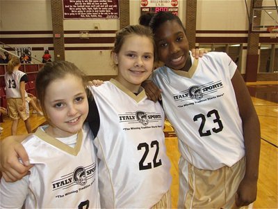 Image: Lean on me — Peyton Henderson(2), Lillie Perry(22) and Janae Robertson(23) lean on one another for support before the game against Hillsboro Black.