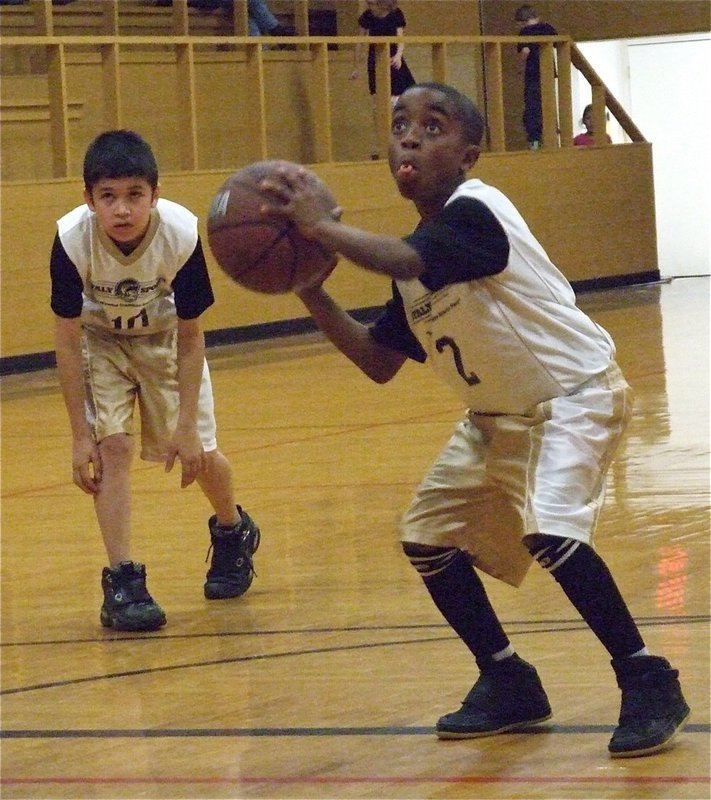 Image: James is at the line — James McIntyre(2) does his best Michael Jordan impersonation before shooting his free throw as Alex Hernandez(10) gets ready to rush in for the rebound.