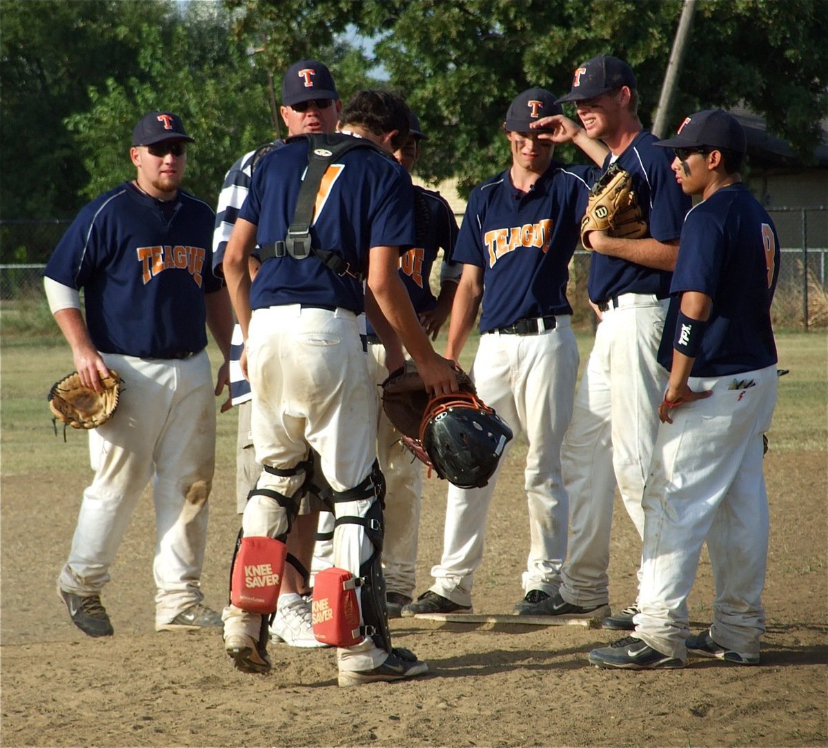 Image: Teague regroups — Teague’s infielders meet with their coach at the mound.