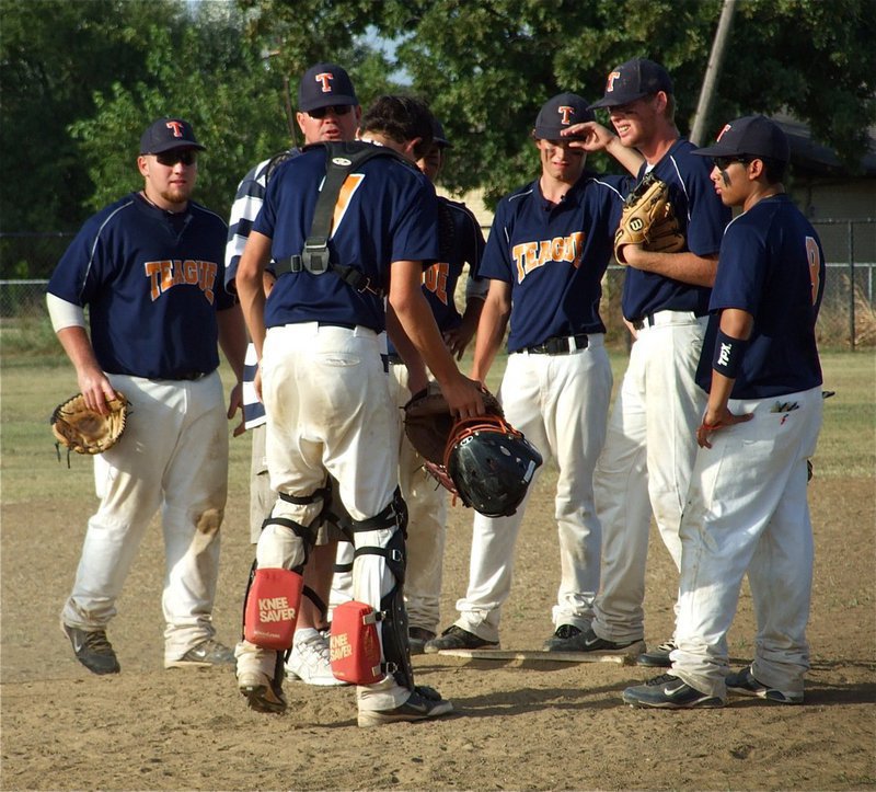 Image: Teague regroups — Teague’s infielders meet with their coach at the mound.
