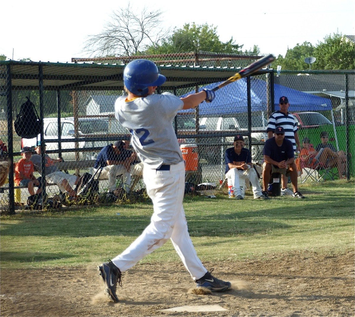 Image: Fun in the sunshine — Jacob “Sunshine” Peterson used his bat to cast a dark shadow over the Teague dugout.