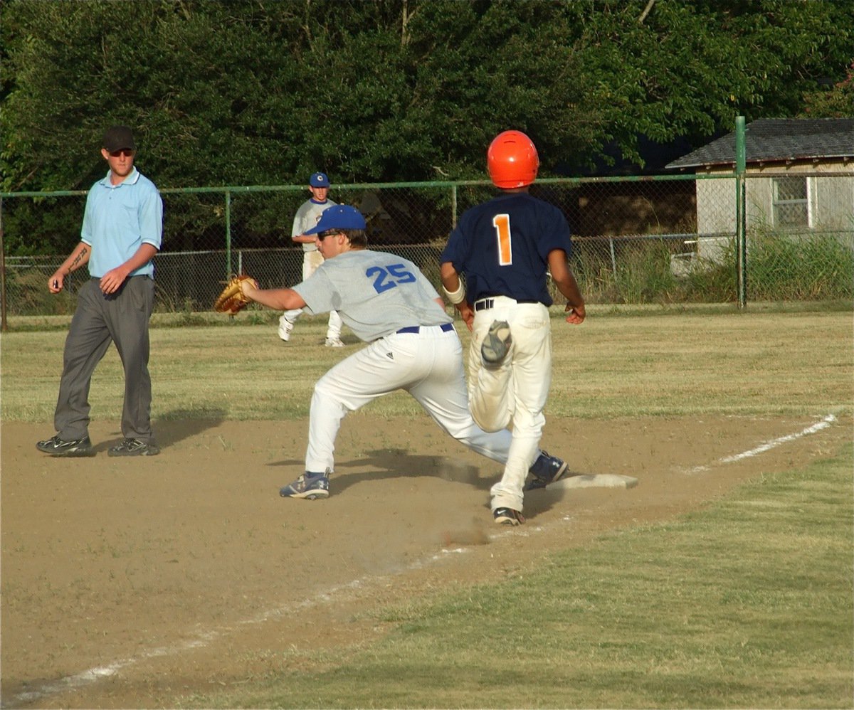 Image: Another out — Corsicana Tigers-Blue’s First baseman Matt Burns sends another Teague runner to the bench.