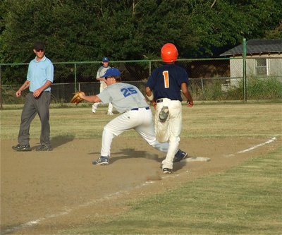 Image: Another out — Corsicana Tigers-Blue’s First baseman Matt Burns sends another Teague runner to the bench.