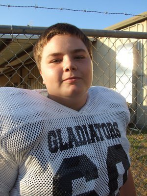 Image: Bales and barbwire — On one side of the fence, Gladiators. On the other side of the fence, Cougars. Italy’s Kelton Bales asks for some wire cutters.