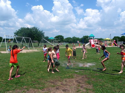 Image: Lets Get Wet — This young man is getting soaked.