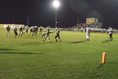 Image: The football is free — The football is up for grabs as it works it way to the endzone.