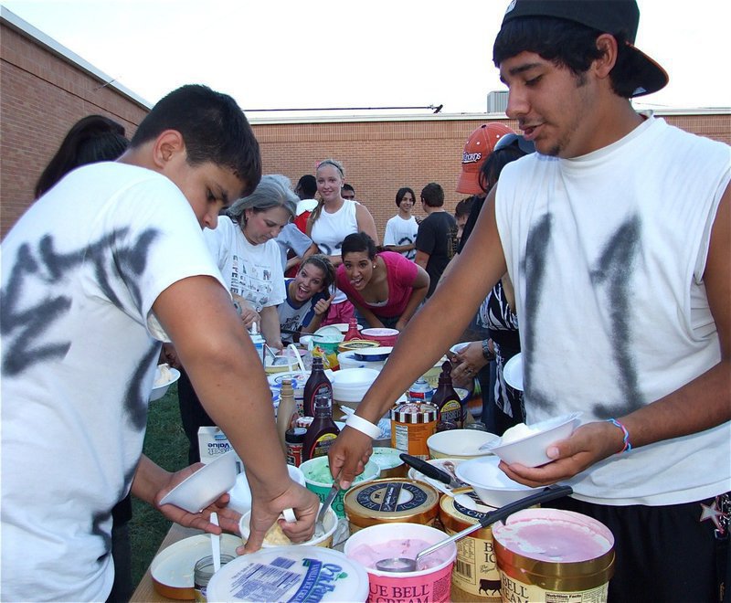 Image: Reid and Taz go for it — Reid Jacinto and Michael “Taz” Martinez dig into the ice cream during the band social. In the background, Morgan Cockerham and Alyssa Richards hope the guys save some for them.