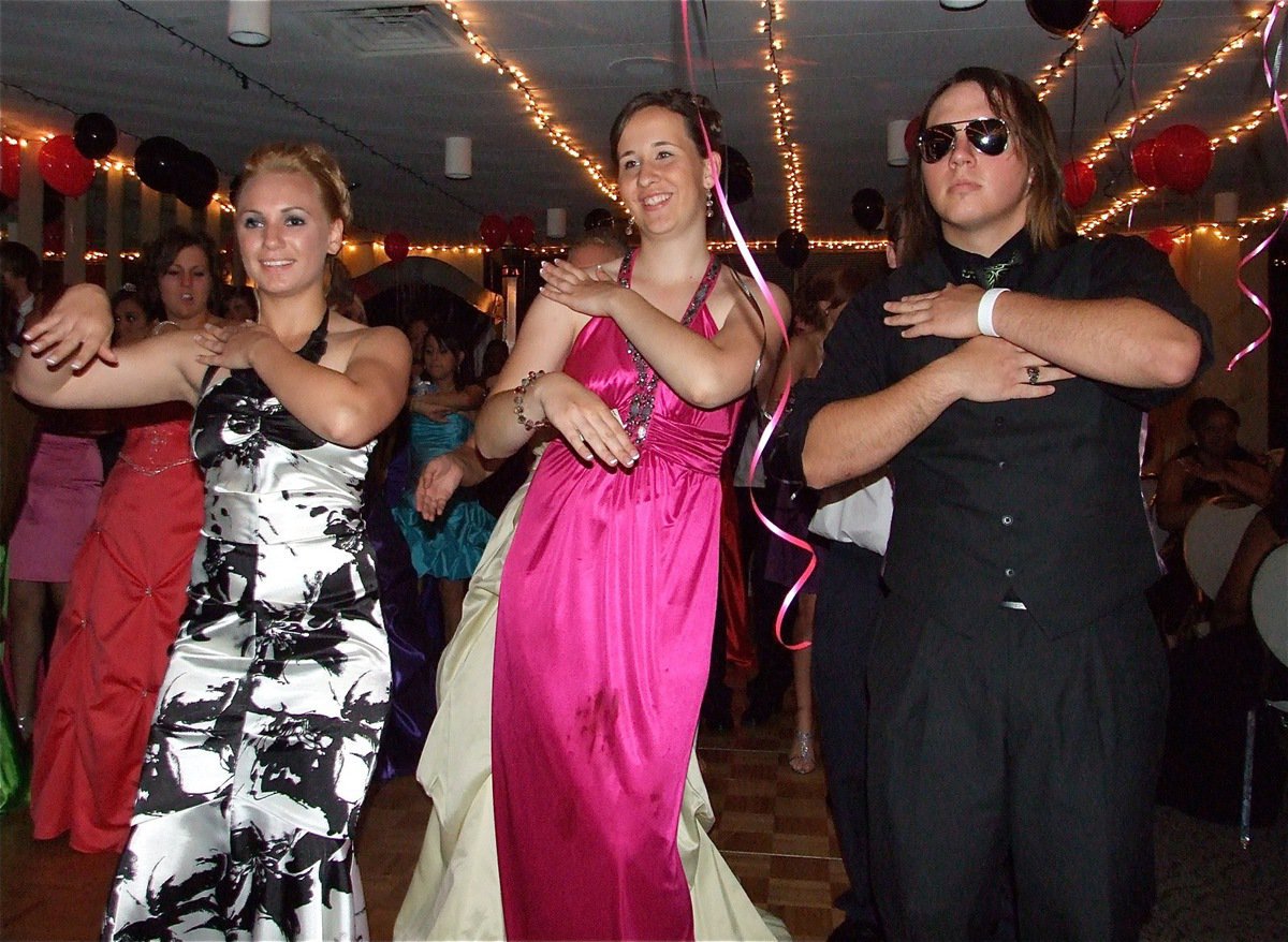 Image: 1, 2, 3… — Mary Tate, Lis Olachewsky and Zachary Hernandez do the Macarena dance.