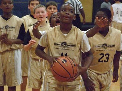 Image: Pressure at the buzzer — Chasston Wilson(11) gets pressure from teammates before shooting to beat the buzzer that signals the end of intermission.