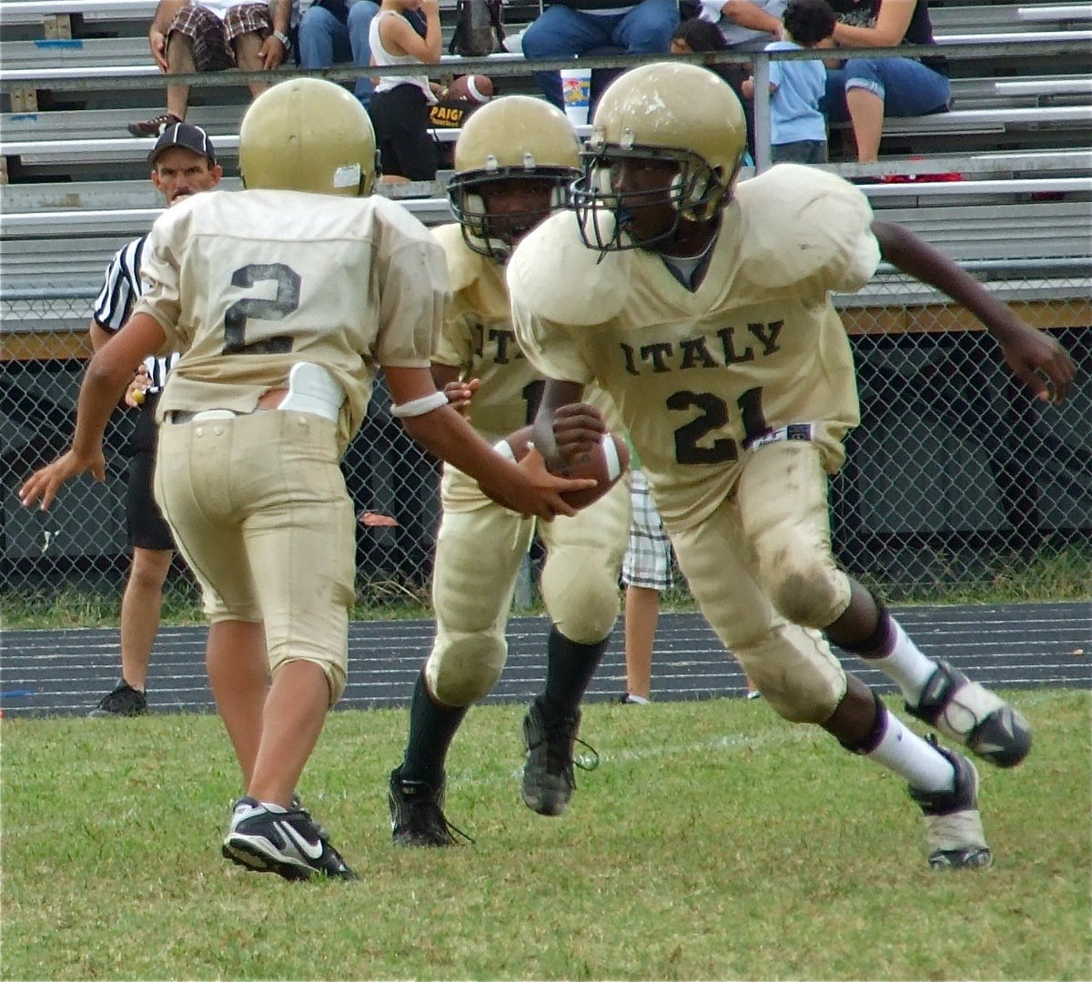 Image: Doing their jobs — Chasston Wilson(21) leads the way for Kendrick Norwood(1) as A-Team quarterback Tylan Wallace hands off to Norwood.