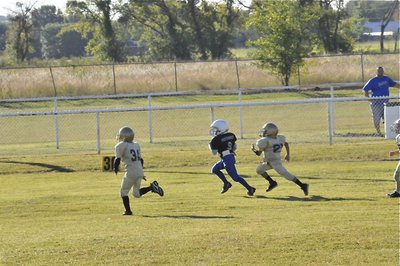 Image: Bulldog catchers — C-Team Gladiators Jaiden Barr(34) and Laveraneus Green(21) catch this runaway Bulldog before he can reach the endzone. The effort helped the C-Team Gladiators earn their first shutout of the season, 19-0.