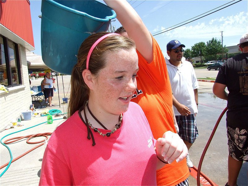 Image: Look out! — Bailey Deborde plans an unsuspecting attack on Reagan Cockerham. Did she or didn’t she pour it?