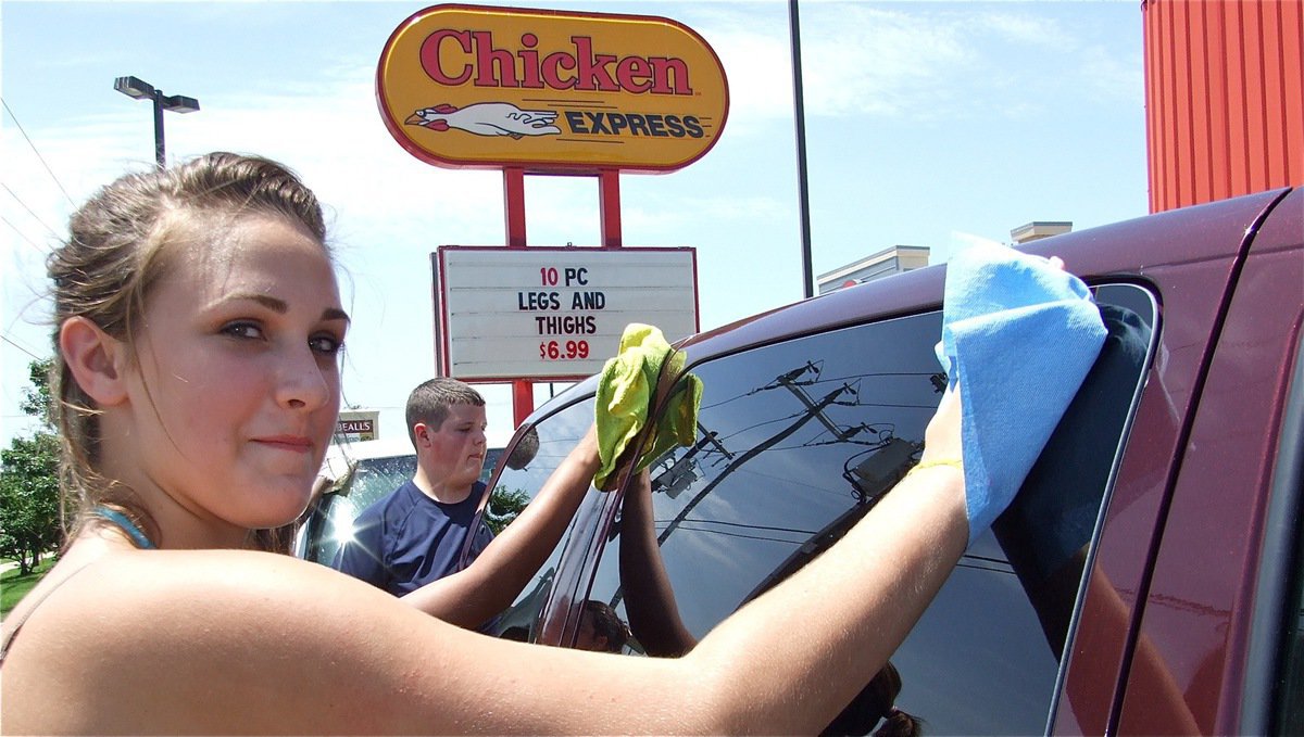 Image: Need a hand? — Briann Perry multitasks while Zachary Mercer dries off the back of the van.