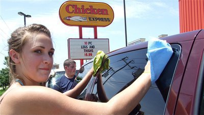 Image: Need a hand? — Briann Perry multitasks while Zachary Mercer dries off the back of the van.