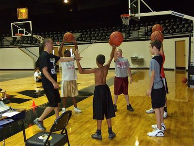 Image: Coach selects winner — Coach Cal points to a winner after a ball handling challenge.