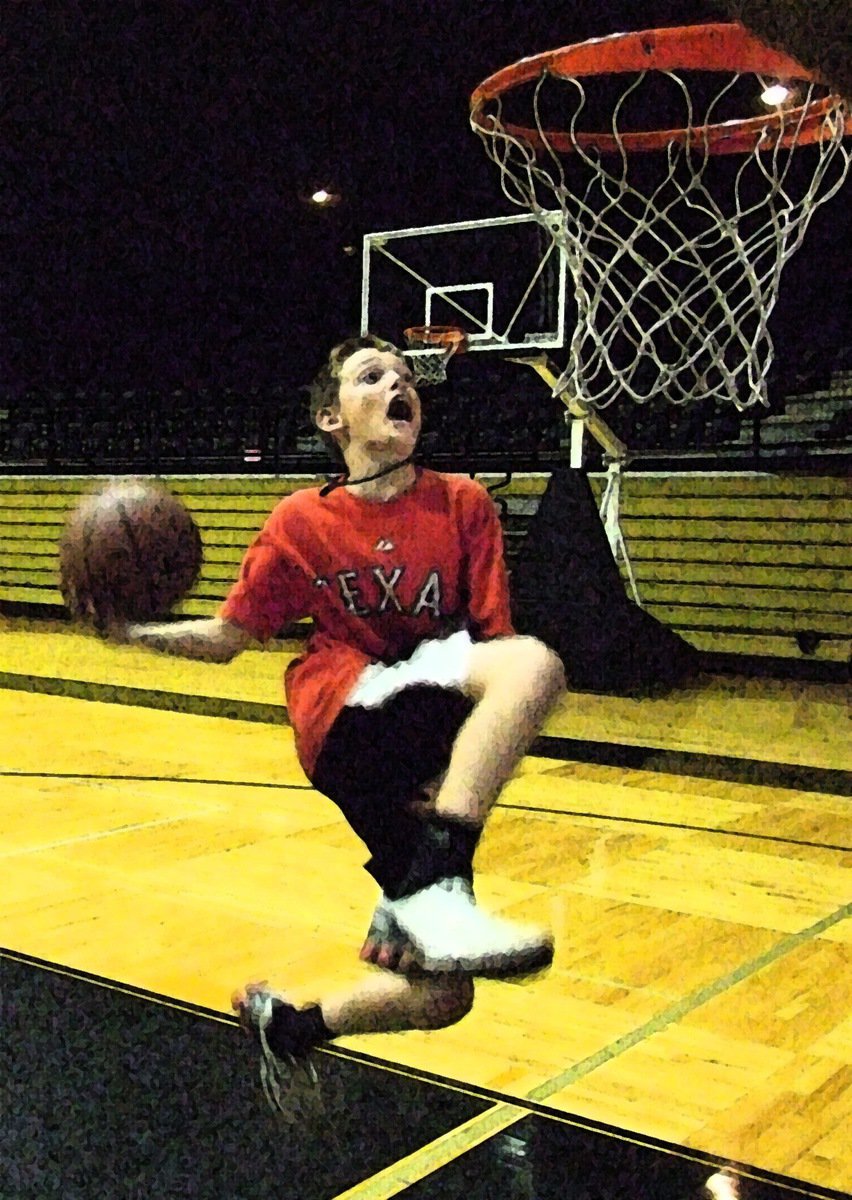 Image: Ty adds flair — Ty Windham cradles the ball on his way to the rim.