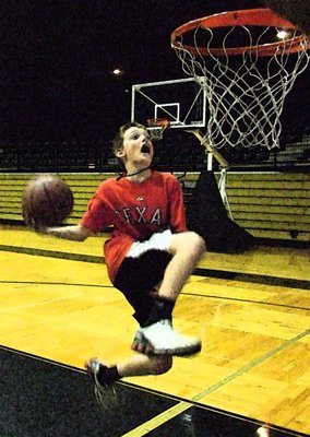 Image: Ty adds flair — Ty Windham cradles the ball on his way to the rim.