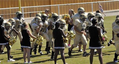 Image: Majors take the field — The IYAA Major Cheerleaders shake their pom-poms as the Majors (5th &amp; 6th) team charges down spirit alley and onto Willis Field.