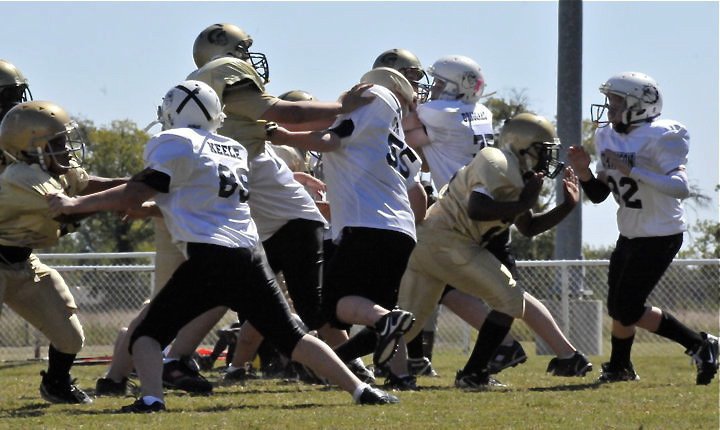 Image: Big-time blocking! — The Majors offensive line attacks the Bulldog defense and leads their team to a 27-0 victory over Dawson.