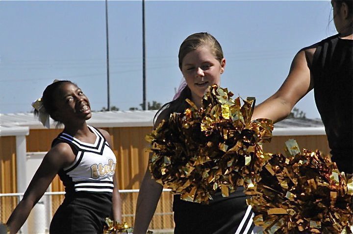 Image: Sideline fun — IYAA Cheerleaders Quintera Washington and Brooke DeBorde have a blast cheering during the games as Italy A, B, C-Teams win all three on Saturday.
