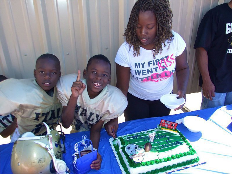 Image: Julius celebrates birthday — Julius Williams(33) celebrates his 7th birthday party with family and teammates after his Bantam team beat Dawson 19-18. Julius’s mother, Jennifer Johnson cuts the cake.
