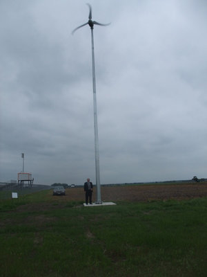 Image: David DelBosque and the Wind Turbine — Mr. DelBosque is happy with his wind turbine.