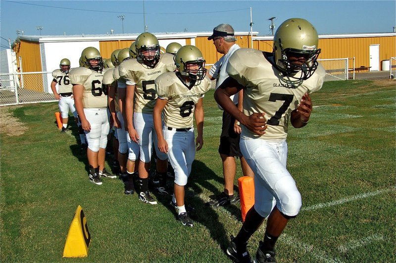 Image: JV takes field — Paul Harris(7) leads the Italy JV Gladiators onto Willis Field.