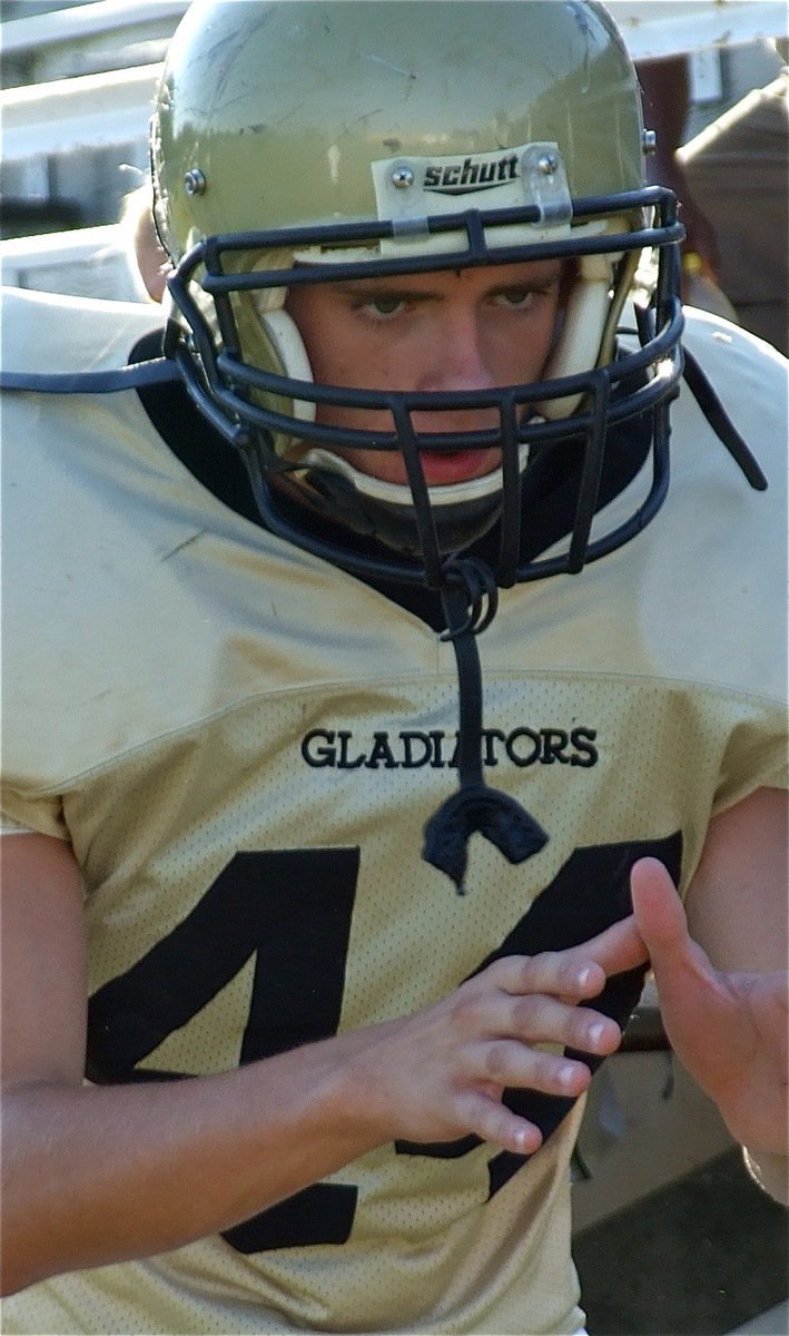 Image: Justin takes snaps — Justin Wood helps center Bailey Walton practice snapping before the game.