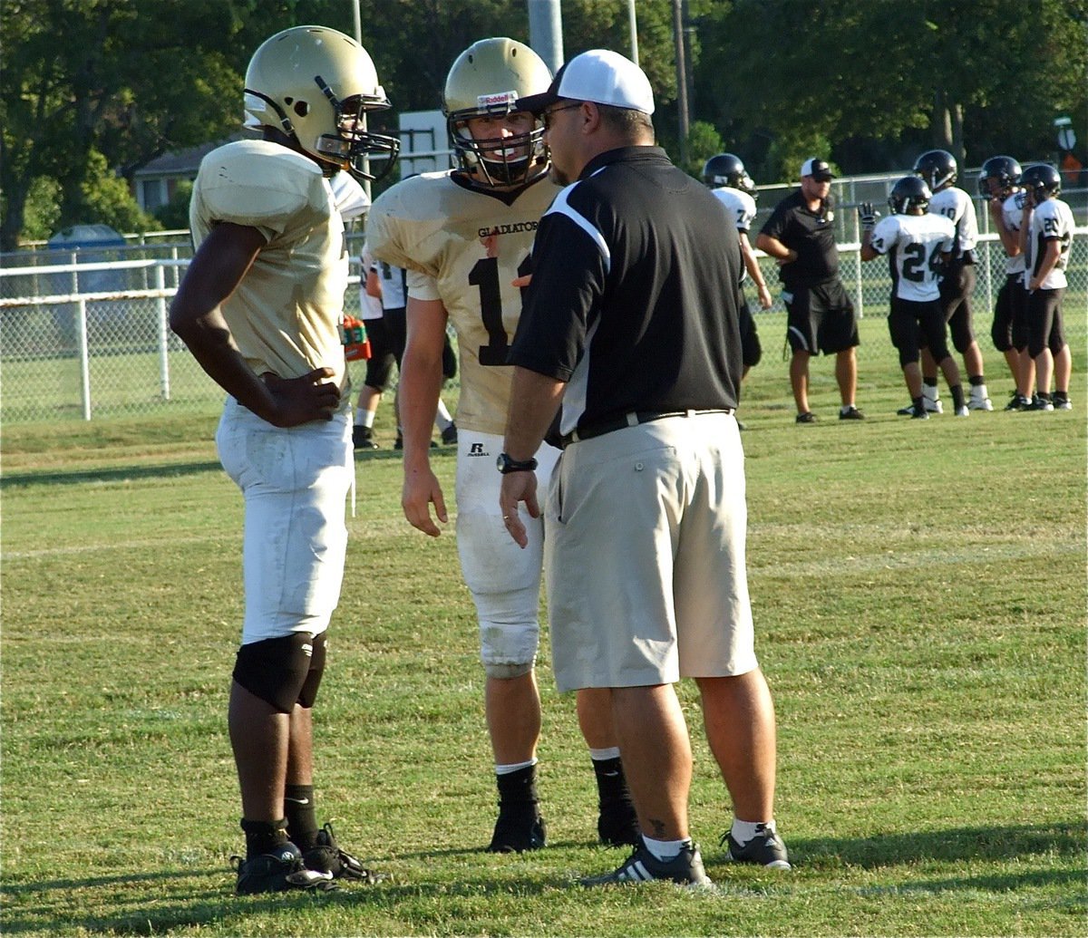 Image: Small huddle — Paul Harris(7) and Chase Hamilton(10) confer with Italy’s Varsity head coach Craig Bales.