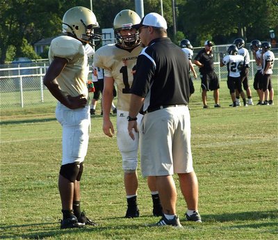 Image: Small huddle — Paul Harris(7) and Chase Hamilton(10) confer with Italy’s Varsity head coach Craig Bales.