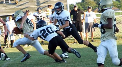 Image: Wood splits — Italy’s Justin Wood(44) splits two Palmer defenders to pickup yards against the Bulldogs’ defense.